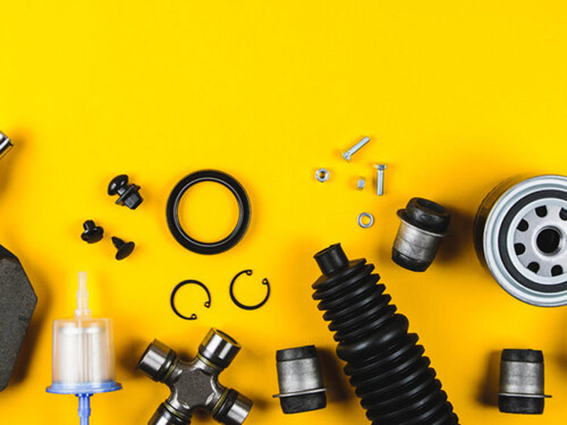 various car engine parts on a yellow background
