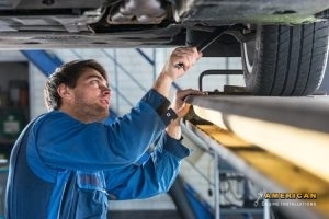 mechanic, examining the suspension of a vehicle