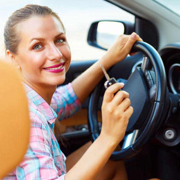 Smiling Woman Starts Her Car