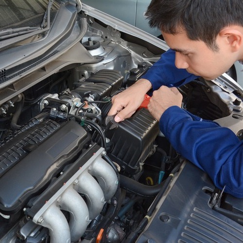technician inspecting engine