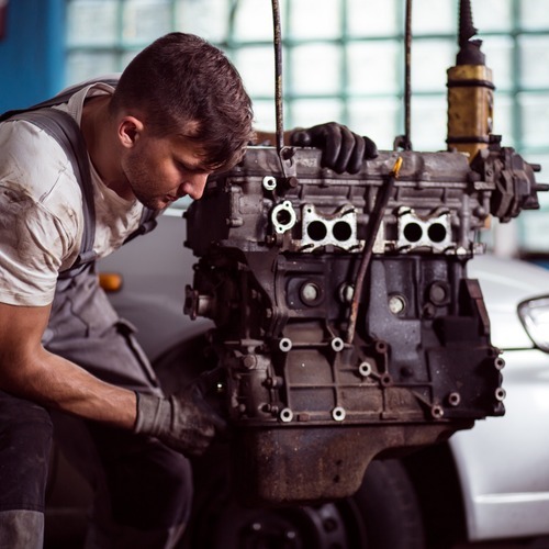technician repairing engine
